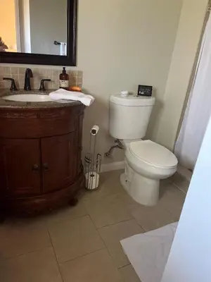 a bathroom with a toilet and a sink and a mirror at Tranquil 1BR Haven Peaceful Stay in Prime Clovis in Clovis