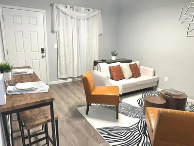 a living room with a couch and a table at Cozy 3 Bedroom Walk to UC Davis Medical Near Midtown in Sacramento