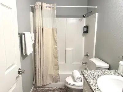 a bathroom with a shower curtain and a toilet at Cozy 3 Bedroom Walk to UC Davis Medical Near Midtown in Sacramento
