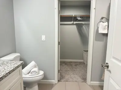 a bathroom with a white toilet and a closet at Cozy 3 Bedroom Walk to UC Davis Medical Near Midtown in Sacramento