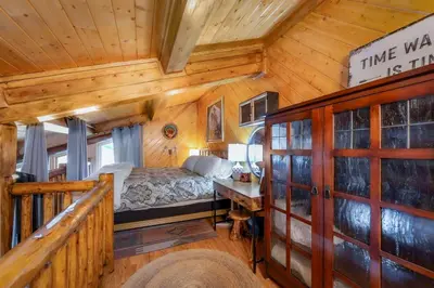 a bedroom in a cabin with a bed and a staircase at Tramway Loft Cozy Stay for 4 in Stateline