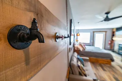 a tap on a wall in a room with a bed at Walk to the lifts hot tub covered parking luxury in Kirkwood