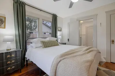 a bedroom with a white bed and a window at 2 bed1 bath, historic beauty, walk downtown in Visalia