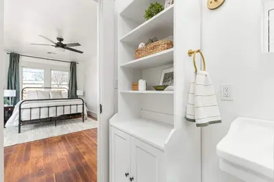 a bathroom with white cabinets and a sink at 2 bed1 bath, historic beauty, walk downtown in Visalia