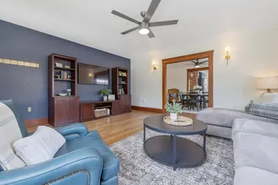 a living room with a blue couch and a table at 2 bed, 2 bath, historic beauty, walk downtown in Visalia