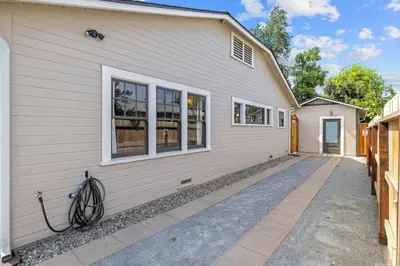 a white house with a driveway in front of it at 2 bed, 2 bath, historic beauty, walk downtown in Visalia