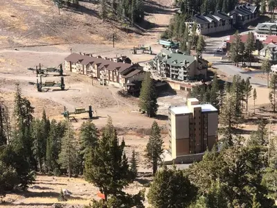 an aerial view of a resort with trees and a building at Ski in Ski out King Bed Suite Hotel Room Near Village in Kirkwood