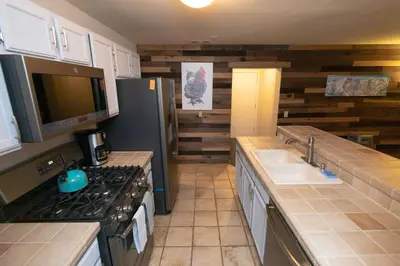 a kitchen with a stove and a sink and a refrigerator at Ski in Ski out Dream Studio Village Mtn Views in Kirkwood