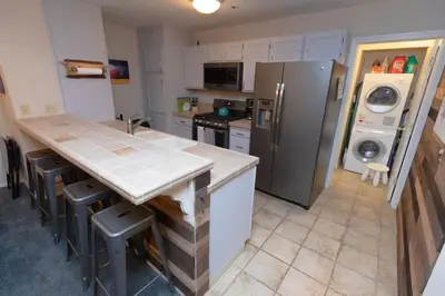 a kitchen with a counter top and a refrigerator at Ski in Ski out Dream Studio Village Mtn Views in Kirkwood