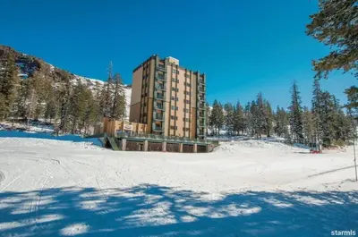 a building in the middle of a snow covered field at True Ski in out Large 2 bdrm Mtn Views 4 beds in Kirkwood