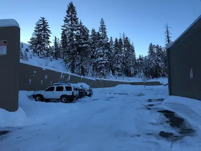 a car parked in a parking lot covered in snow at True Ski in out Large 2 bdrm Mtn Views 4 beds in Kirkwood