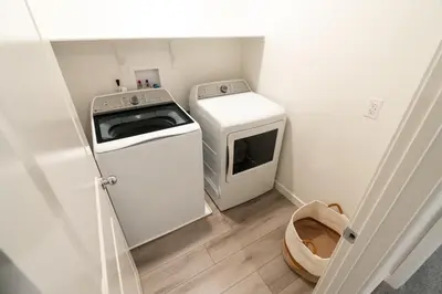 a small kitchen with a washing machine and a washer at Beautiful Modern Home with Outdoor Patio and BBQ Grill in Elk Grove