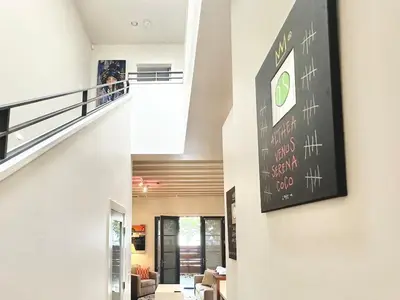 a hallway of a house with a sign on the wall at Modern 2 Bedroom by Midtown Walk Distance to Bars and Restaurants in Sacramento