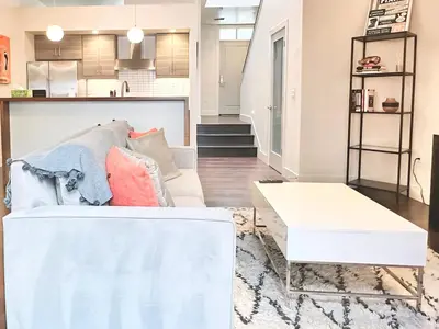 a living room with a couch and a table at Modern 2 Bedroom by Midtown Walk Distance to Bars and Restaurants in Sacramento