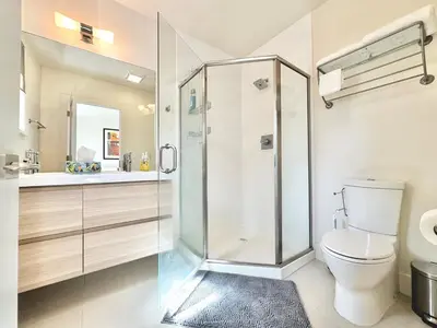 a bathroom with a shower and a toilet and a sink at Modern 2 Bedroom by Midtown Walk Distance to Bars and Restaurants in Sacramento