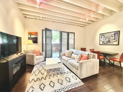 a living room with a couch and a table at Modern 2 Bedroom by Midtown Walk Distance to Bars and Restaurants in Sacramento
