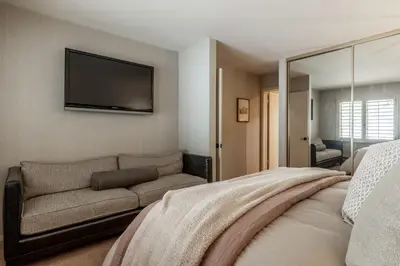 a bedroom with a couch and a flat screen tv at Bridges 3 in Mammoth Lakes