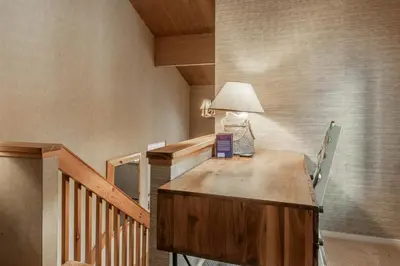 a room with a wooden desk with a lamp on it at Bridges 3 in Mammoth Lakes
