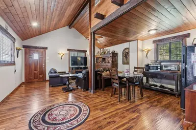 a living room with wooden ceilings and a wooden floor at Gorgeous cottage in fair oaks village in Fair Oaks