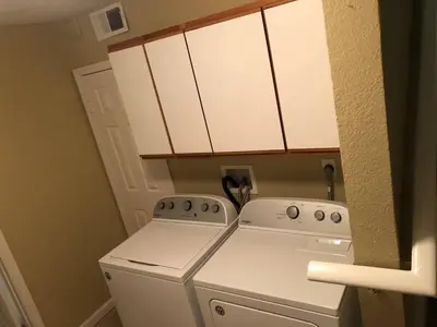 a small kitchen with a white stove and cabinets at Magnificent stay at fair oaks village in Fair Oaks