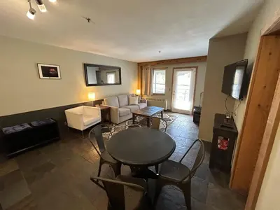 a living room with a table and a couch at The Meadows- Modern 1BedroomDeck and Fireplace in Kirkwood