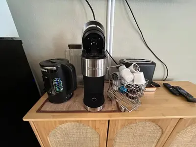 a coffee maker sitting on top of a wooden table at The Meadows Modern Suite Deck & Garage Parking in Kirkwood