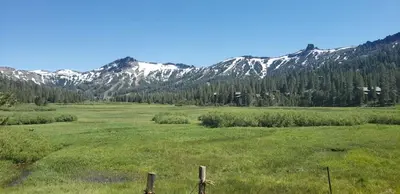 a large open field with mountains in the background at The Meadows Modern Suite Deck & Garage Parking in Kirkwood
