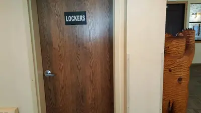 a wooden door with a sign on it at The Meadows Modern Suite Deck & Garage Parking in Kirkwood