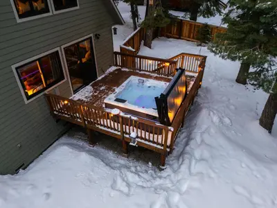 a hot tub on a deck in the snow at Starlight Chalet Lake Tahoe in Carnelian Bay