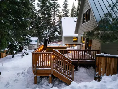 a house with a deck in the snow at Starlight Chalet Lake Tahoe in Carnelian Bay