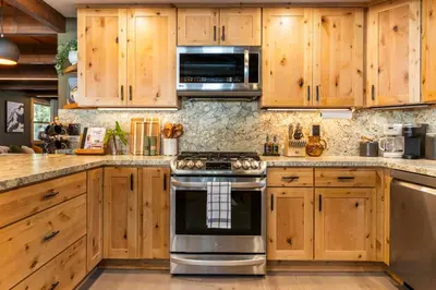 a kitchen with wooden cabinets and a stove at Starlight Chalet Lake Tahoe in Carnelian Bay