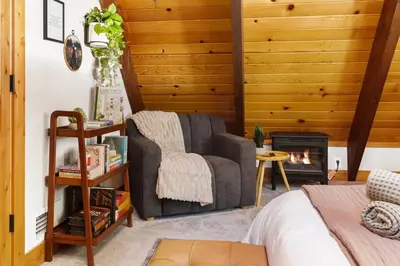 a living room with a chair and a fireplace at Starlight Chalet Lake Tahoe in Carnelian Bay