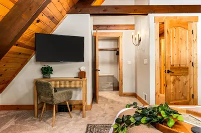 a living room with a television on a wall at Starlight Chalet Lake Tahoe in Carnelian Bay