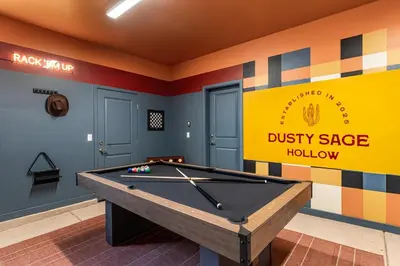 a billiard table in a room with a dustsy sage holiday sign at Dusty Sage Hollow in Fernley