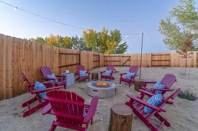 a group of chairs and a fire pit in a backyard at Dusty Sage Hollow in Fernley