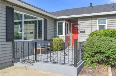 a house with a balcony with a red door at Pet-Friendly Home - Big Yard for Family Stays in Sacramento