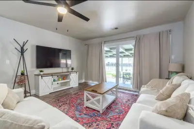 a living room with two white couches and a tv at Pet-Friendly Home - Big Yard for Family Stays in Sacramento