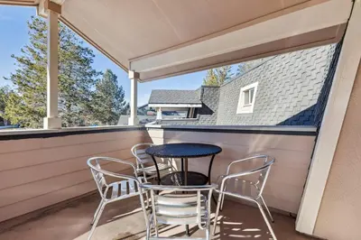 a patio with a table and chairs on a porch at 2253 Catalina Drive home in South Lake Tahoe