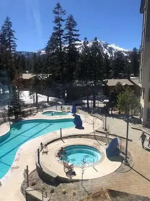 a large swimming pool in front of a building at Mammoth Monache Resort in Mammoth Lakes