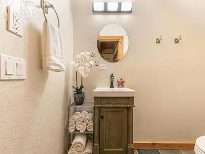 a bathroom with a sink and a mirror at Family cabin on resort at Northstar in Truckee