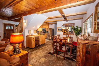 a kitchen and living room with a table and a couch at Nightingale's Nest in Carnelian Bay