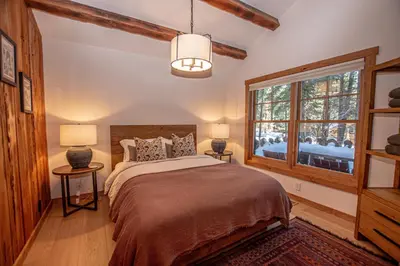 a bedroom with a bed and a window at Cedar Cottage in Homewood