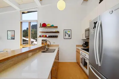 a kitchen with a sink and a refrigerator at Alpine Meadows Basecamp in Alpine Meadows