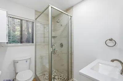 a bathroom with a shower and a toilet and a sink at Shaver Escape Hot Tub Cabin Retreat with AC in Shaver Lake