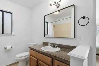 a bathroom with a sink and a mirror at Shaver Escape Hot Tub Cabin Retreat with AC in Shaver Lake