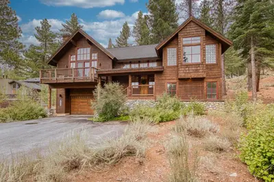 a large wooden house with a driveway at Easy Living at Northstar by Tahoe Getaways - 4BR Pet Friendly w/ Ski Shuttle & HOA in Truckee