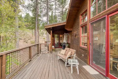 a wooden porch of a cabin with a chair on it at Easy Living at Northstar by Tahoe Getaways - 4BR Pet Friendly w/ Ski Shuttle & HOA in Truckee