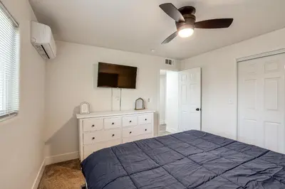 a bedroom with a bed and a ceiling fan at Under 1 Mi to Med Center! Stylish Home in Tulare in Tulare