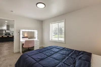 a bedroom with a bed and a desk and a window at Under 1 Mi to Med Center! Stylish Home in Tulare in Tulare