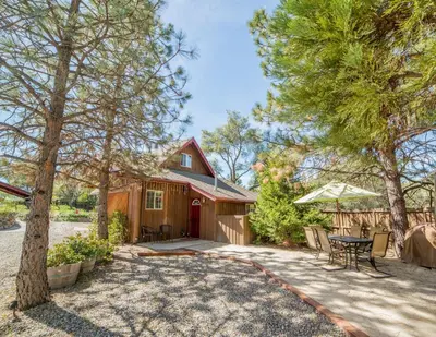 a house with a patio and a table and chairs at Nature's Inn Bed and Breakfast in Ahwahnee